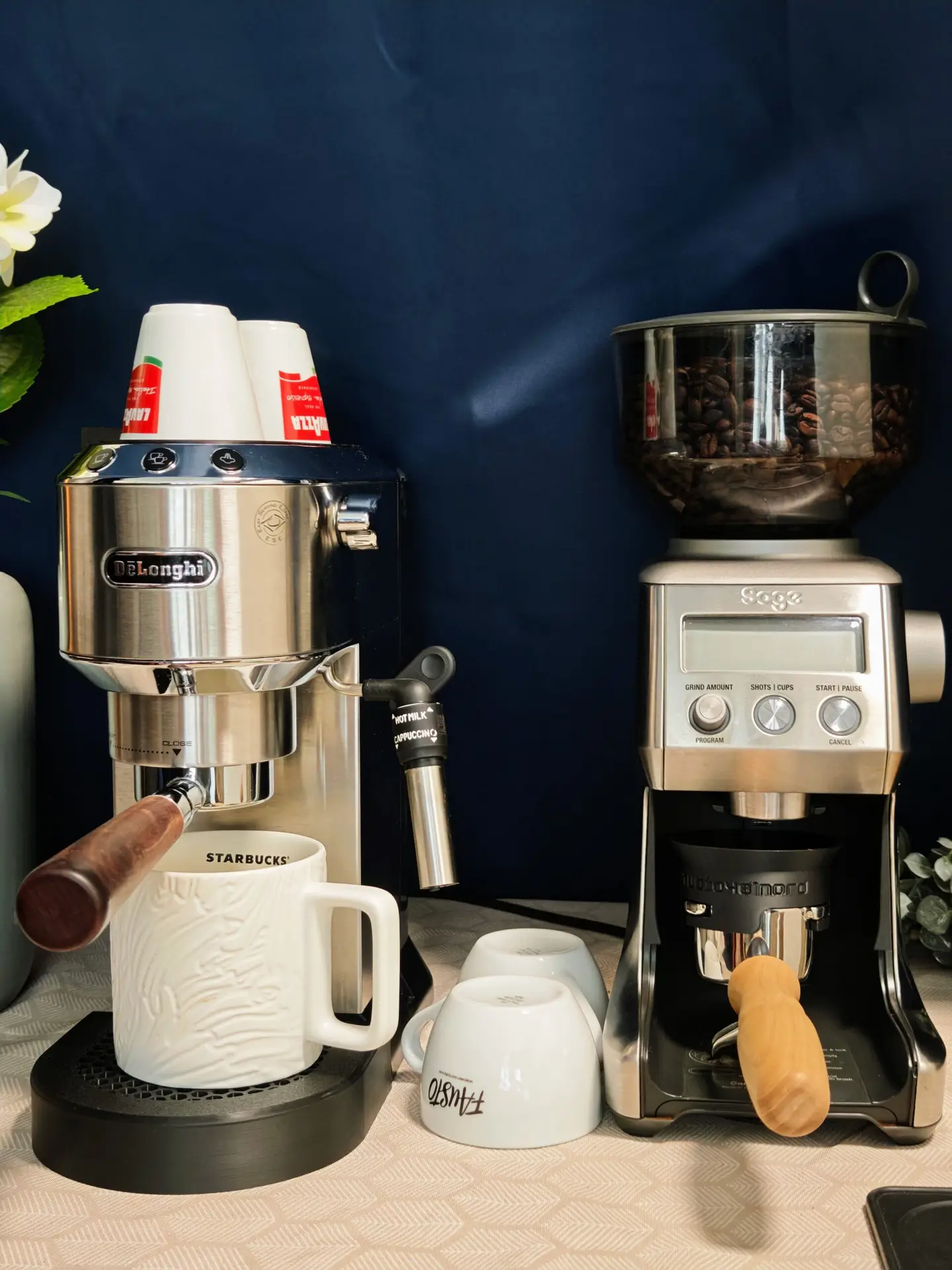Coffee corner with De'Longhi Dedica, grinder and cups on the countertop